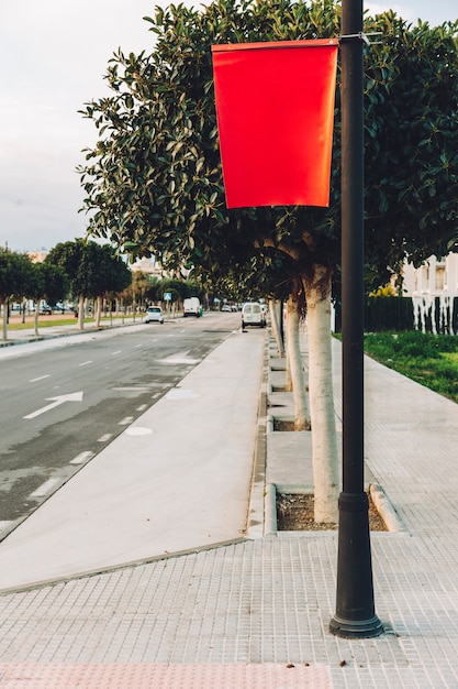 Empty red flag post on street