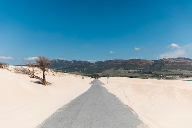 Free Photo empty road in sands against mountains