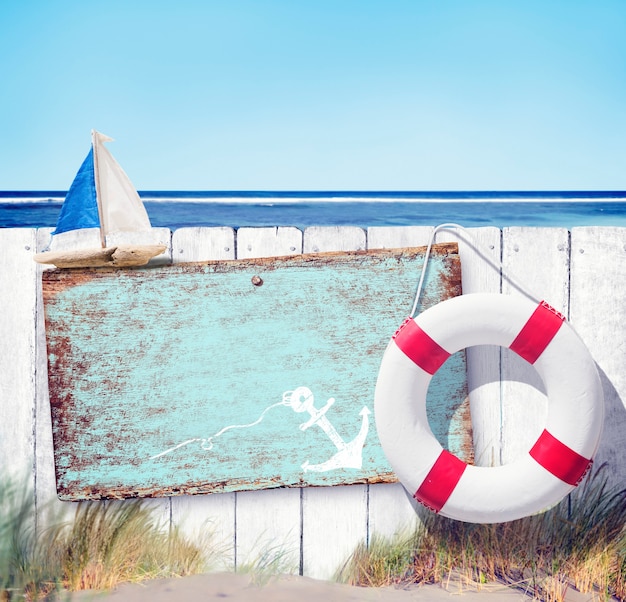 Free Photo empty sign board and wooden fence on beach