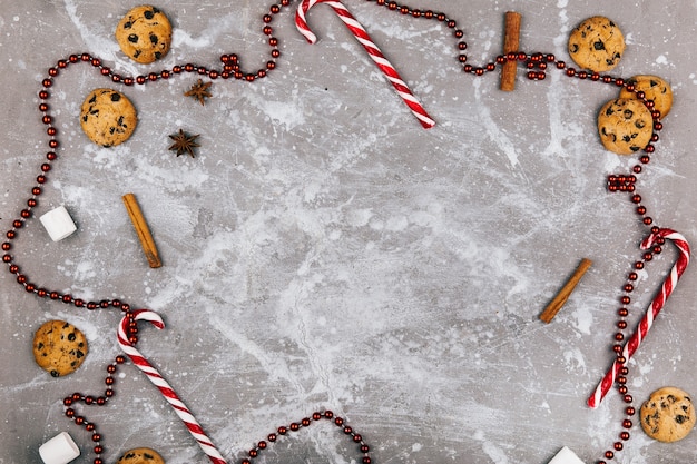 Free photo empty spaces inside of a circle of spices, cookies, red white candies and red garland