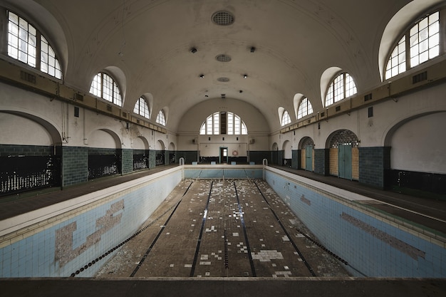 Empty swimming pool inside an old abandoned building