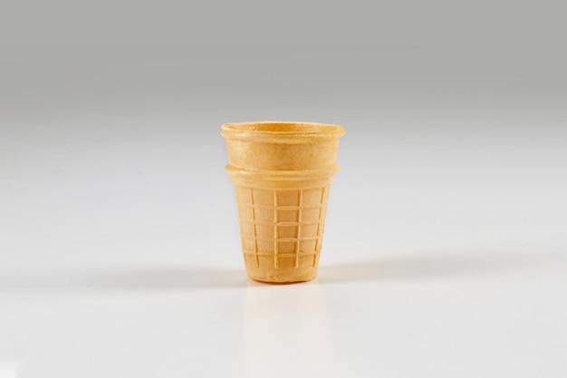 Free photo empty, toasty wafer cup for ice cream isolated on white. concept of food, treats. mockup, template for your advertising and design. close up