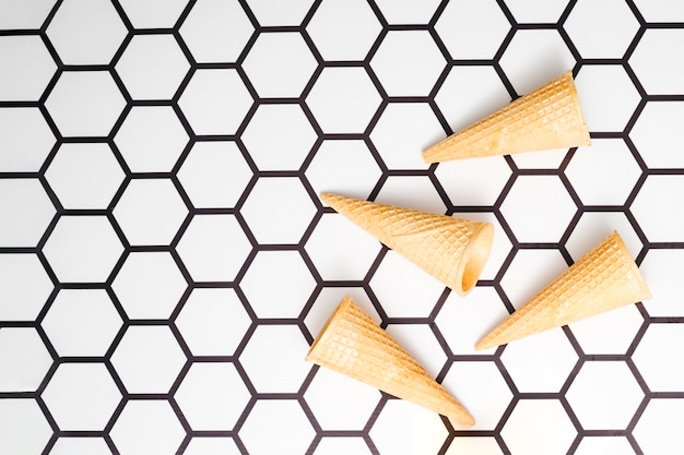 Empty waffle cones on hexagon background