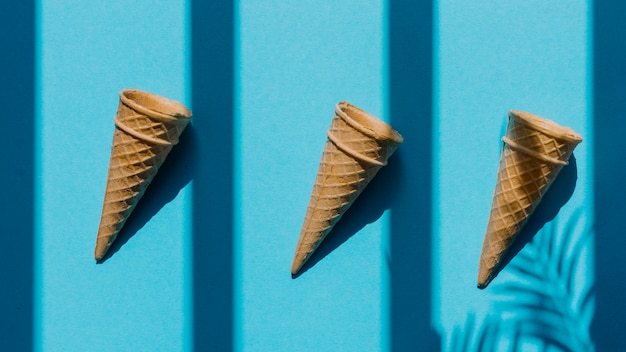 Free Photo empty waffle cones in row on table