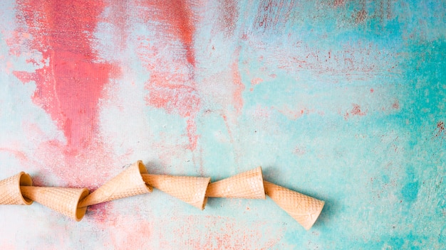 Empty waffle cups on colorful background