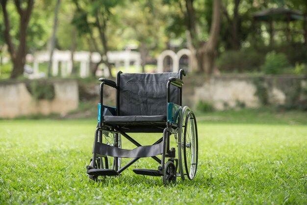 Empty wheelchair parked in park, Health care concept.