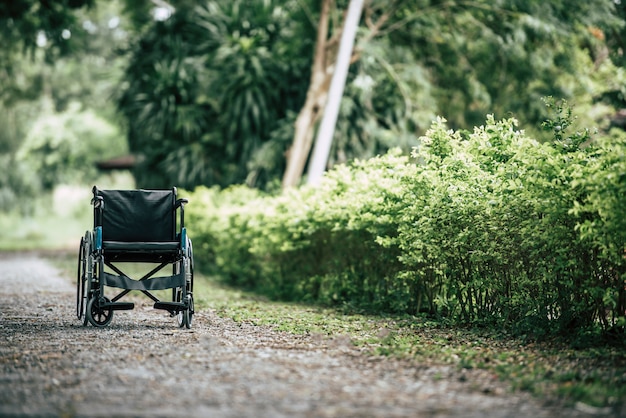 Free photo empty wheelchair parked in park, health care concept.