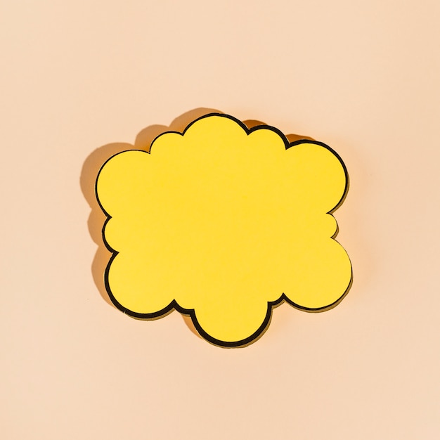 An empty yellow speech bubble on beige background