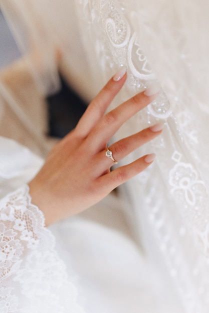 Free photo engagement ring with a stone on the gentle bride's hand