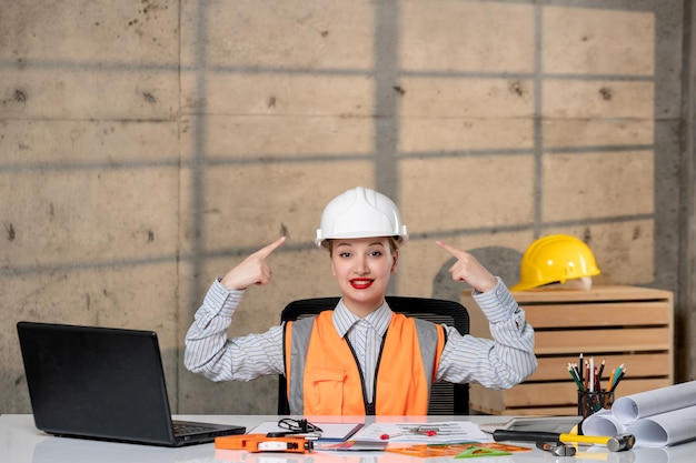 Engineer civil worker in helmet and vest smart young cute blonde girl very proud