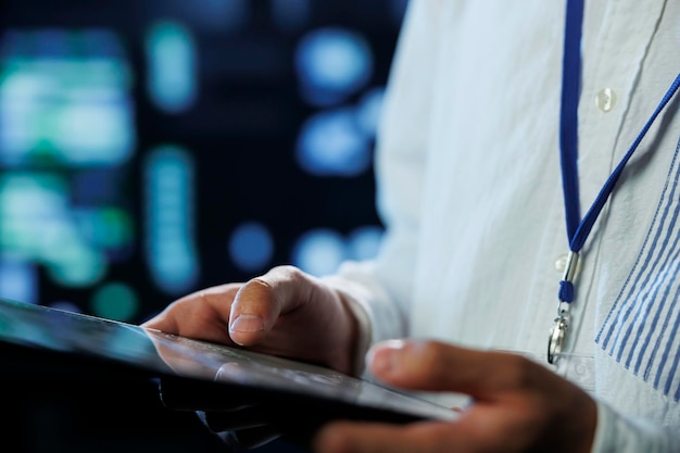 Free Photo engineer in data center using tablet to prevent system overload close up employee in server room ensuring there is enough network connectivity for smooth operations blurry background