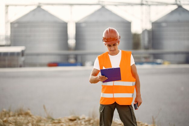 Free Photo engineer in a helmet standing by the factory