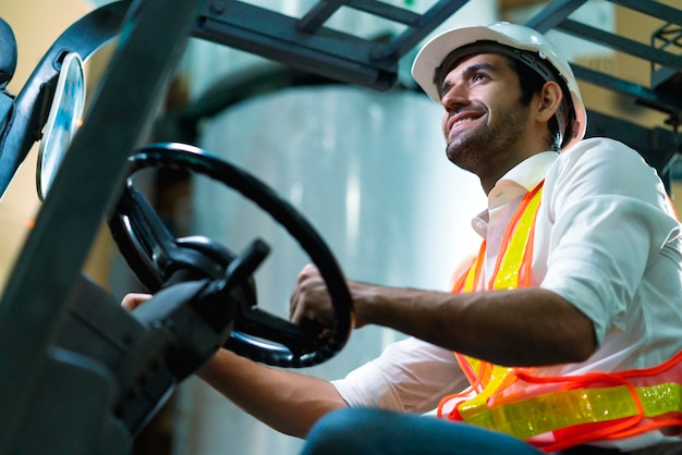 Engineer staff male warehouse worker in hard hat working walking through logistics center warehouse factory construction site logistics architect forklife driver man builder indoors background