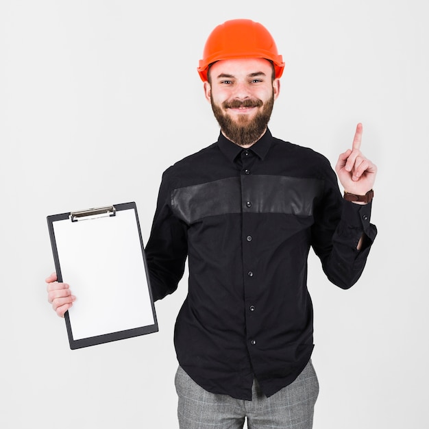 Free photo an engineer wearing hardhat holding clipboard gesturing