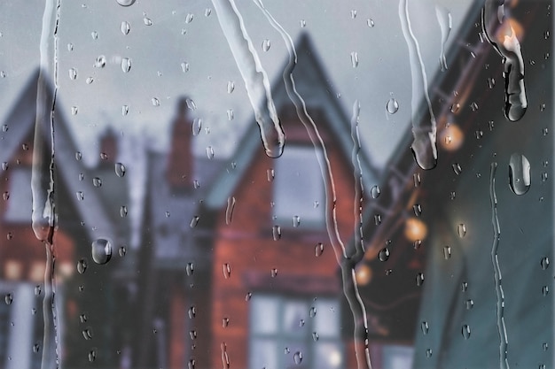 Free Photo english apartments view through window with rain drops