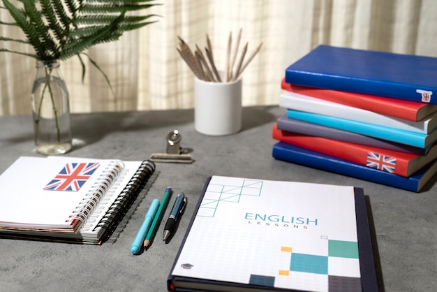 English books stacks on table of working space