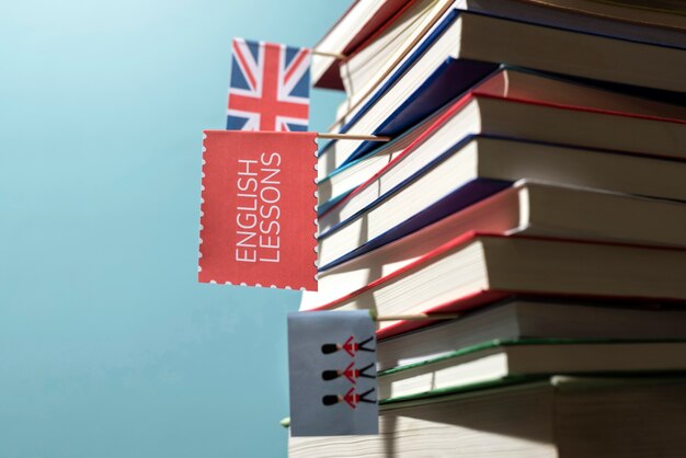 English books stacks on table of working space