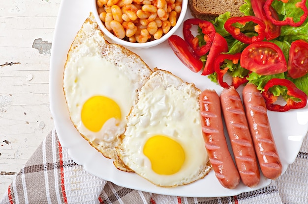 English breakfast - sausages, eggs, beans and salad