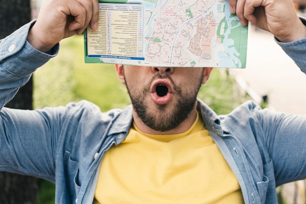 Free Photo enthusiastic man holding a map