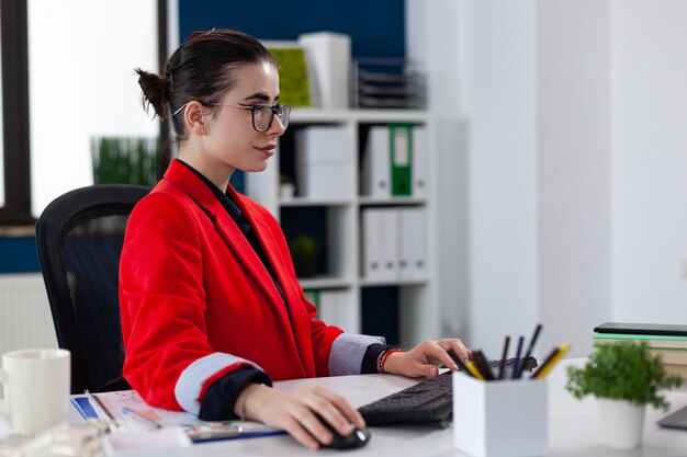 entrepreneur in business corporate office workplace working on laptop using wireless mouse