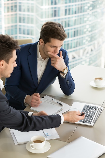 Entrepreneurs discussing work results on meeting