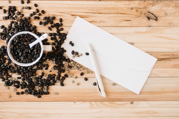 Envelope near cup with coffee beans