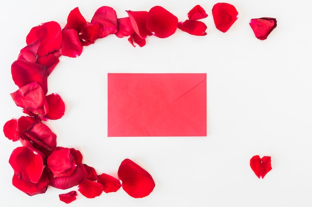 Free photo envelope near set of red flower petals