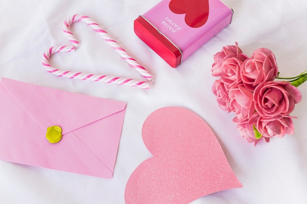 Envelope with big paper heart on table