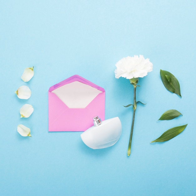 Envelope with white flower on blue table