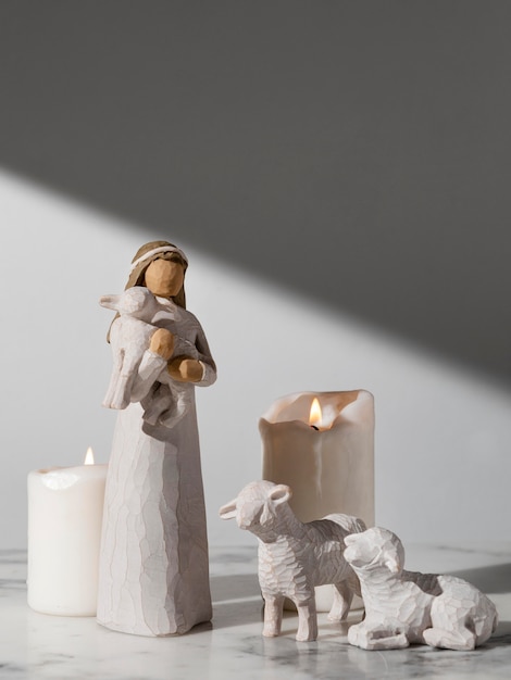 Free photo epiphany day female figurine with sheep and candles