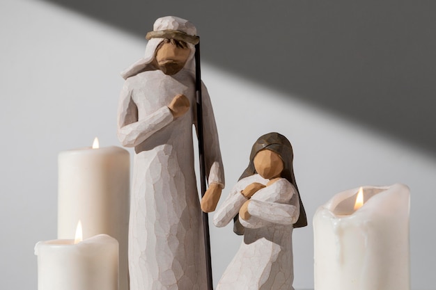 Free Photo epiphany day female and male figurine with candles and newborn