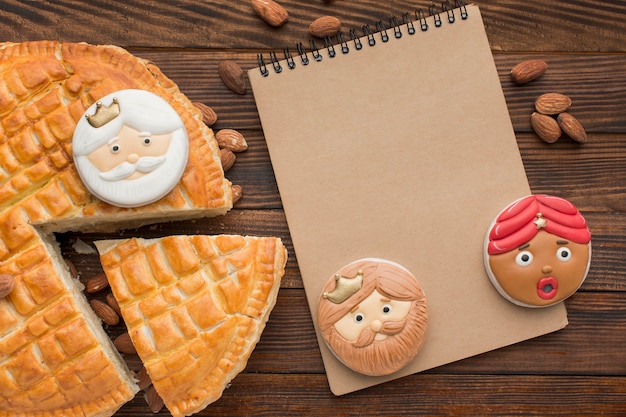 Epiphany dessert biscuits and pie with notepad