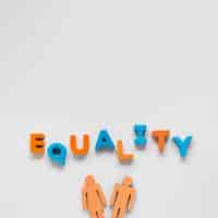 Free photo equality lettering with toy man and woman