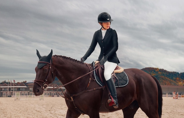 Free Photo equestrian sport young girl rides on horse on championship