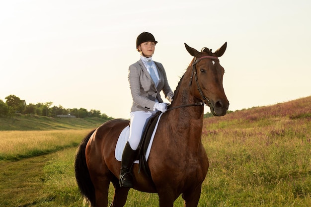 Free photo equestrian sport. young woman riding horse on dressage advanced test