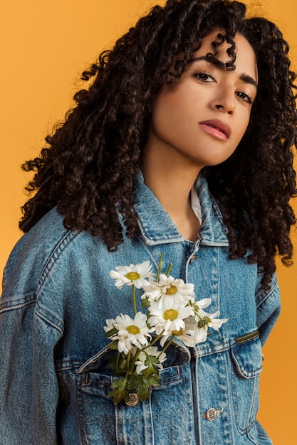 Free photo ethnic woman with flowers in jacket