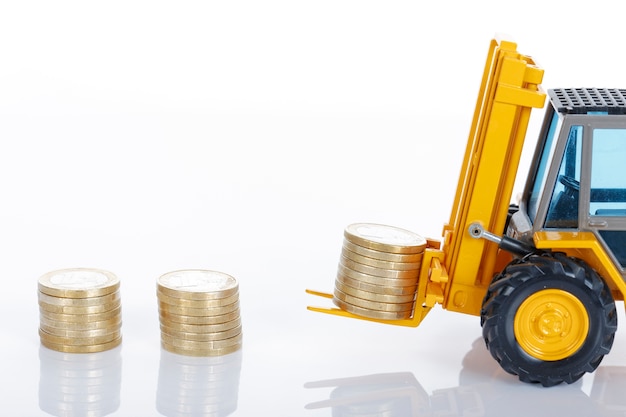 Free Photo euro money coins and forklift isolated on white space