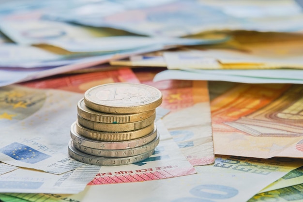 Free photo euro money euro currency coins stacked on top of each other in different positions against the background of euro banknotes business finance concept business news splash screen banner mockup