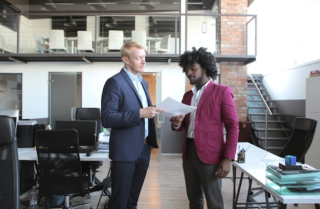 European and African-American business partners discussing a contract during a business meeting