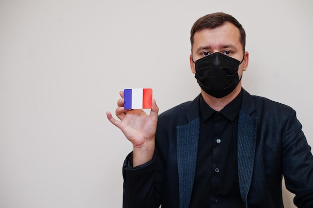 Free photo european man wear black formal and protect face mask hold france flag card isolated on white background europe coronavirus covid country concept