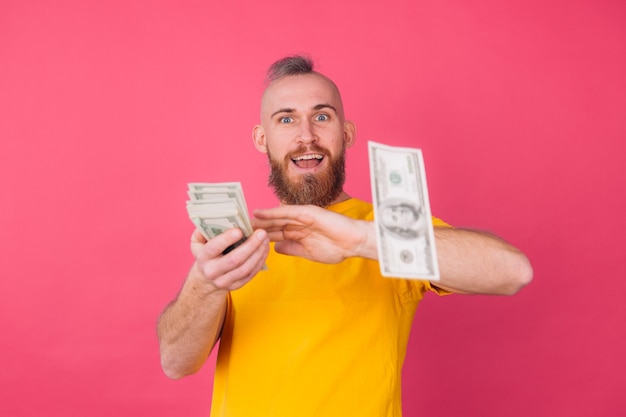 Free Photo european man, with fan on 100 dollars happy excited throwing in air isolated space