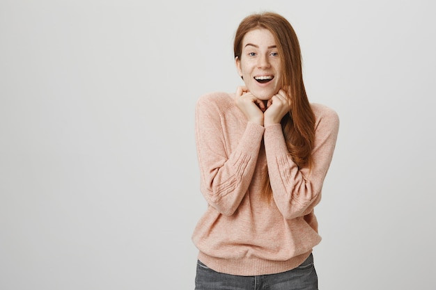 Excited adorable redhead woman smiling cheerful