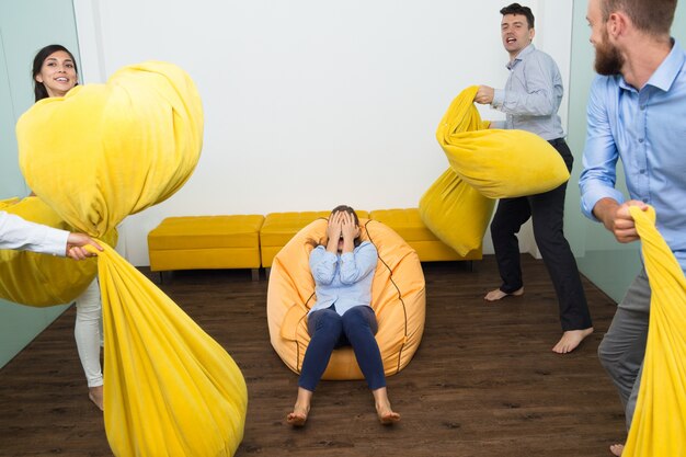 Excited Adult Friends Fighting With Pillows