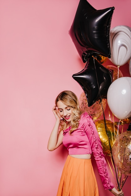 Free photo excited blonde woman preparing for party