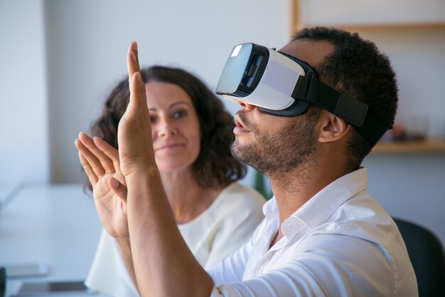 Excited colleagues testing VR simulator together