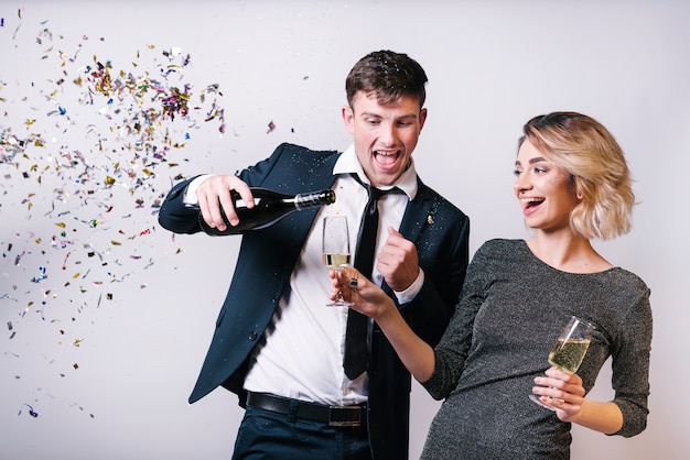 Free photo excited couple enjoying champagne