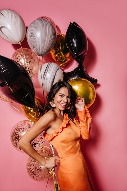 Free photo excited dark-haired woman enjoying party shooting