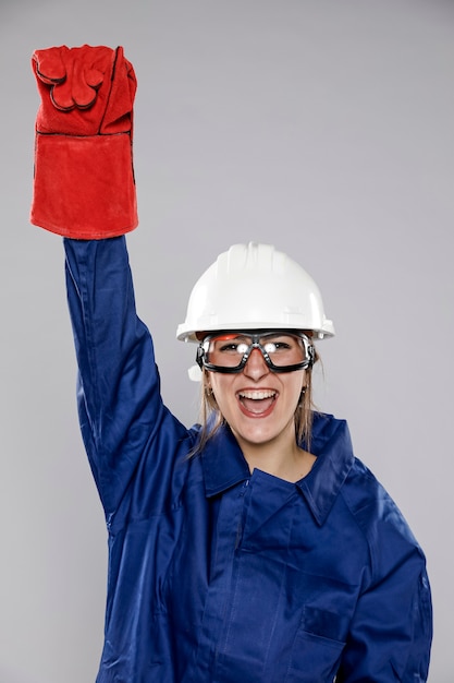 Excited female construction worker with helmet