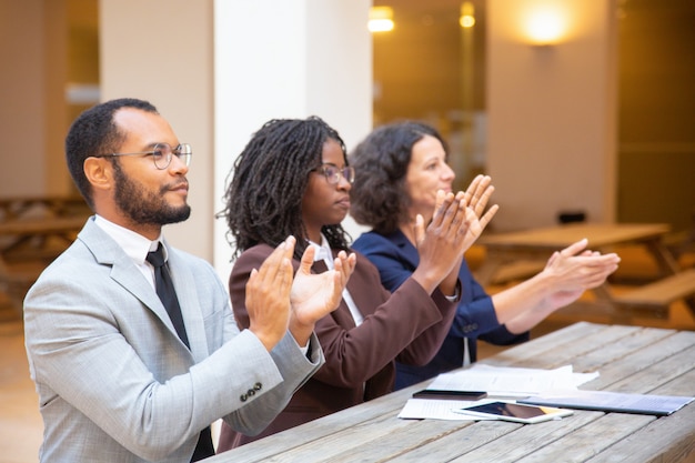 Excited inspired business people applauding speaker