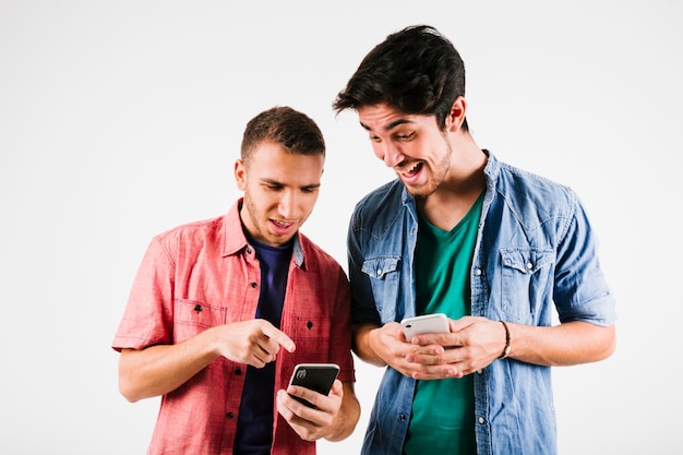 Excited men watching smartphones